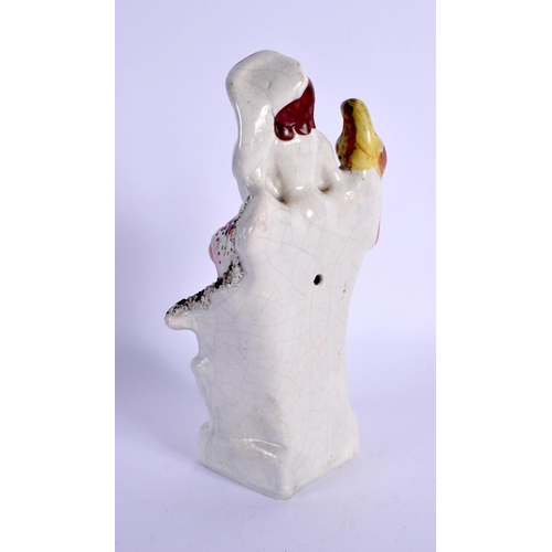 269 - A 19TH CENTURY STAFFORDSHIRE FIGURE OF A FEMALE modelled holding a bird. 18 cm x 6 cm.