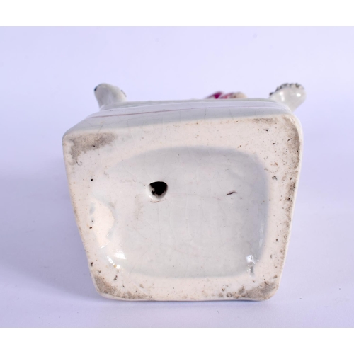 269 - A 19TH CENTURY STAFFORDSHIRE FIGURE OF A FEMALE modelled holding a bird. 18 cm x 6 cm.