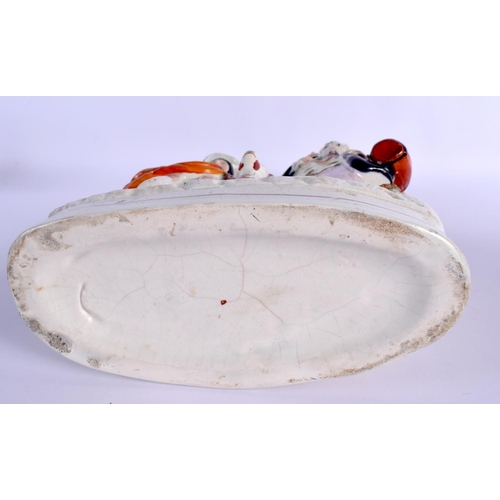 271 - A LARGE 19TH CENTURY STAFFORDSHIRE FIGURE OF A MALE AND FEMALE modelled with a dog and horn. 32 cm x... 