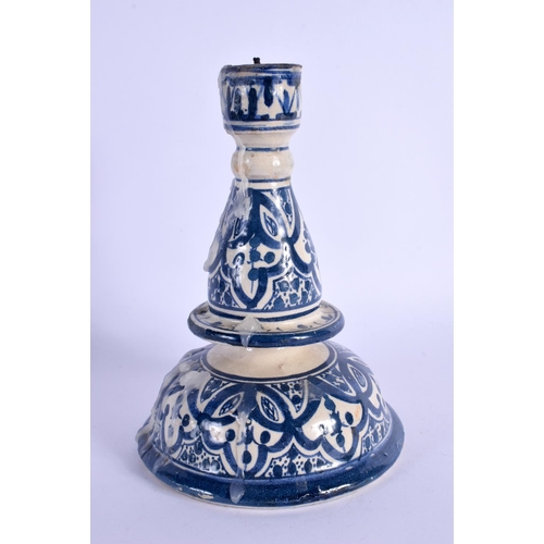 275 - AN ISLAMIC MIDDLE EASTERN FAIENCE POTTERY CANDLESTICK. 16 cm x 8 cm.