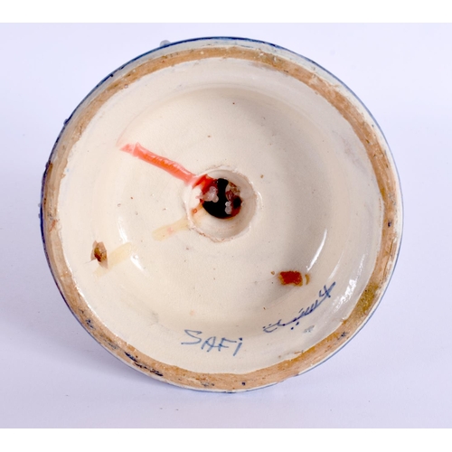 275 - AN ISLAMIC MIDDLE EASTERN FAIENCE POTTERY CANDLESTICK. 16 cm x 8 cm.