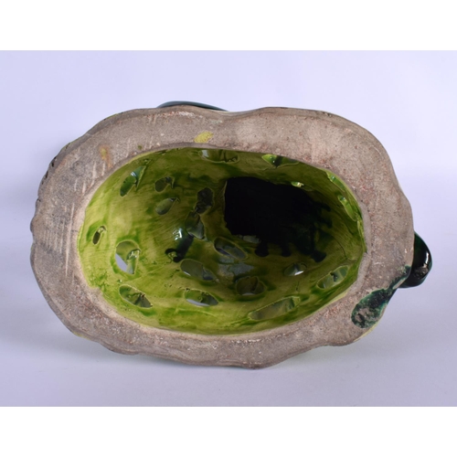 281 - A LARGE EARLY 20TH CENTURY CONTINENTAL POTTERY FIGURE OF A PARROT modelled upon a naturalistic stump... 