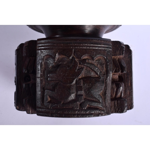 339 - A RARE NEAR PAIR OF 17TH/18TH CENTURY INDIAN CARVED WOOD MORTARS carved with Buddhistic figures. Lar... 
