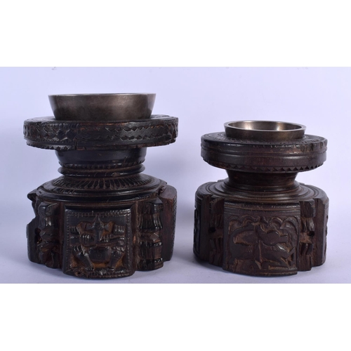 339 - A RARE NEAR PAIR OF 17TH/18TH CENTURY INDIAN CARVED WOOD MORTARS carved with Buddhistic figures. Lar... 