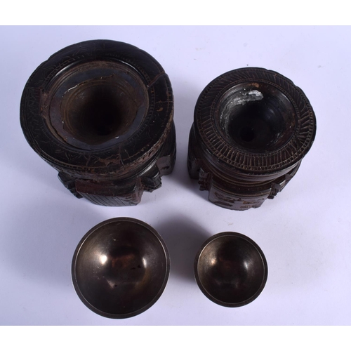339 - A RARE NEAR PAIR OF 17TH/18TH CENTURY INDIAN CARVED WOOD MORTARS carved with Buddhistic figures. Lar... 