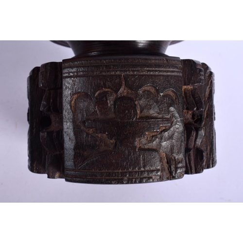 339 - A RARE NEAR PAIR OF 17TH/18TH CENTURY INDIAN CARVED WOOD MORTARS carved with Buddhistic figures. Lar... 