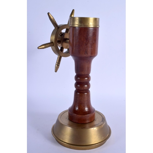 349 - AN UNUSUAL NOVELTY 1940S BRASS COMPASS SHIPS WHEEL DESK ORNAMENT. 24 cm x 10 cm.