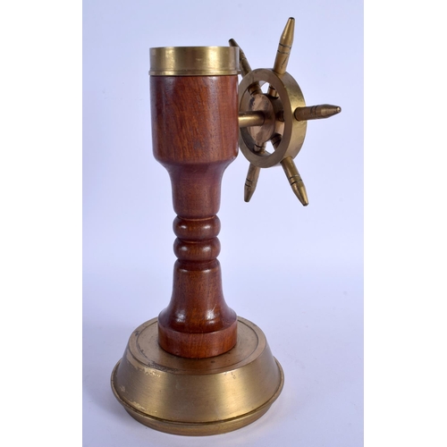 349 - AN UNUSUAL NOVELTY 1940S BRASS COMPASS SHIPS WHEEL DESK ORNAMENT. 24 cm x 10 cm.
