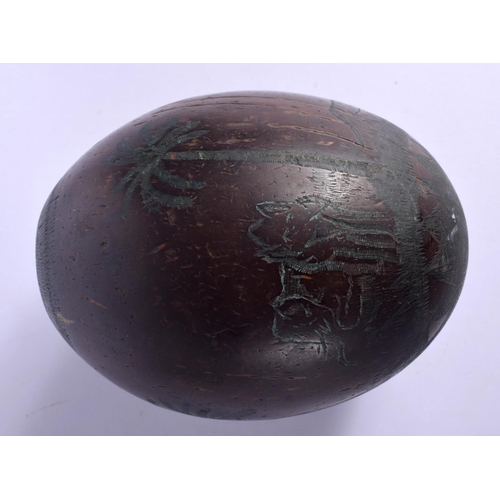 354 - AN EARLY 20TH CENTURY INDIAN CARVED PUNA COCONUT SHELL decorated with figures. 12.5 cm x 9 cm.