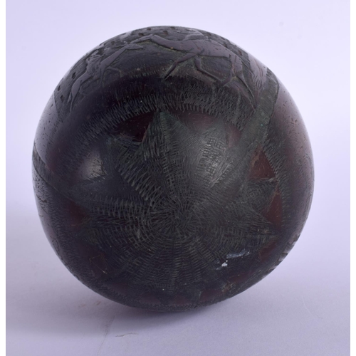 354 - AN EARLY 20TH CENTURY INDIAN CARVED PUNA COCONUT SHELL decorated with figures. 12.5 cm x 9 cm.