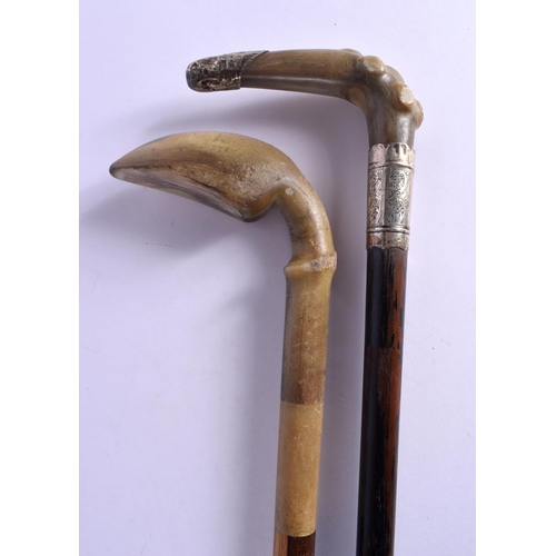 403 - TWO 19TH CENTURY CONTINENTAL CARVED RHINOCEROS HORN WALKING CANES. 90 cm long. (2)