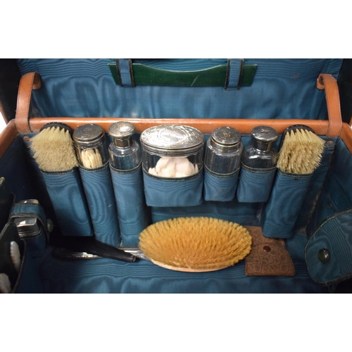 428 - AN ANTIQUE LEATHER CASED TRAVELLING SILVER VANITY CASE with fitted interior. 42 cm x 32 cm x 22 cm.