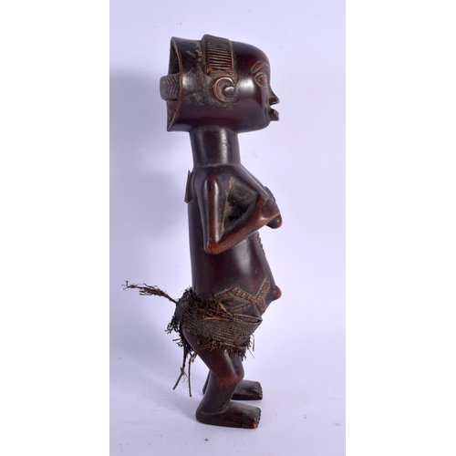 437 - AN AFRICAN TRIBAL LUBA FEMALE FIGURE modelled clutching her breasts. 27 cm high.