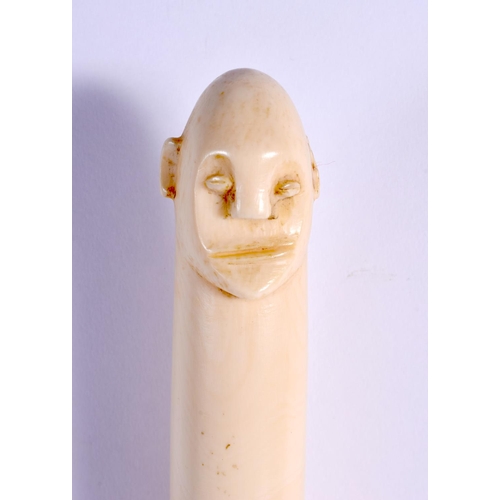 442 - A RARE 19TH CENTURY AFRICAN TRIBAL CARVED IVORY OLIPHANT INSTRUMENT with figural terminal. 54 cm lon... 