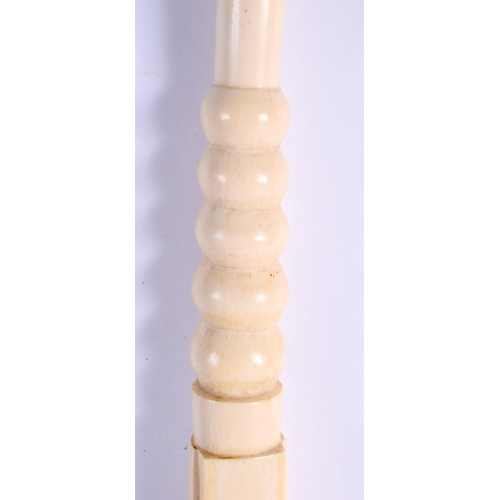 442 - A RARE 19TH CENTURY AFRICAN TRIBAL CARVED IVORY OLIPHANT INSTRUMENT with figural terminal. 54 cm lon... 