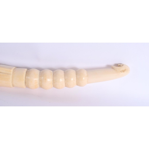 442 - A RARE 19TH CENTURY AFRICAN TRIBAL CARVED IVORY OLIPHANT INSTRUMENT with figural terminal. 54 cm lon... 