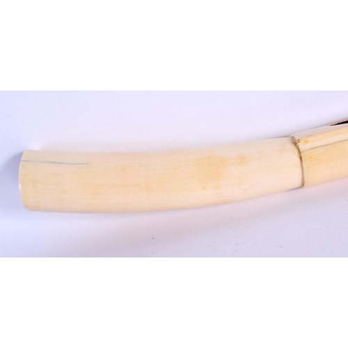 442 - A RARE 19TH CENTURY AFRICAN TRIBAL CARVED IVORY OLIPHANT INSTRUMENT with figural terminal. 54 cm lon... 