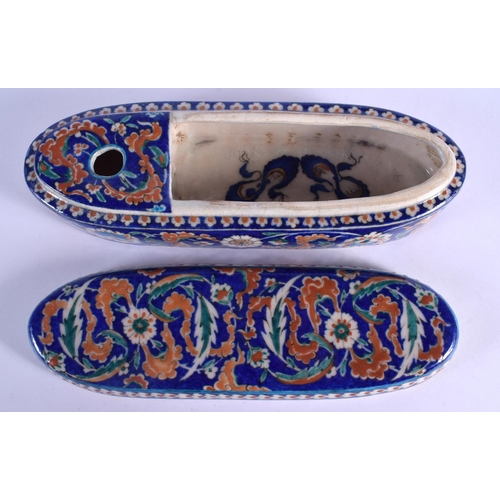 59 - A TURKISH OTTOMAN IZNIK PEN BOX AND COVER painted with flowers. 28 cm x 9 cm.