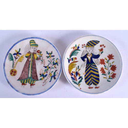 60 - A PAIR OF TURKISH OTTOMAN KUTAHYA PLATES painted with figures. 13 cm diameter.