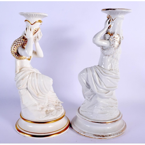 63 - A PAIR OF 19TH CENTURY EUROPEAN WHITE GLAZED PORCELAIN CANDLESTICKS painted with figures. 26 cm high... 