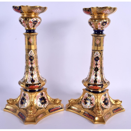 66 - A LARGE PAIR OF ROYAL CROWN DERBY IMARI CANDLESTICKS painted with flowers. 28.5 cm high.