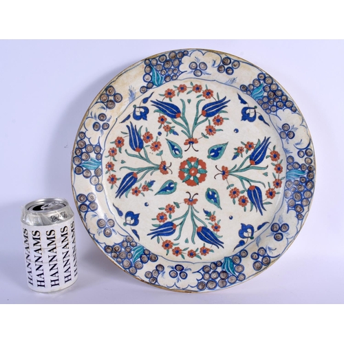 67 - A LARGE OTTOMAN TURKISH IZNIK FAIENCE PLATE painted with flowers. 32 cm diameter.