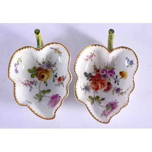 71 - A PAIR OF 19TH CENTURY EUROPEAN PORCELAIN LEAF SHAPED DISHES painted with flowers. 10 cm x 6 cm.