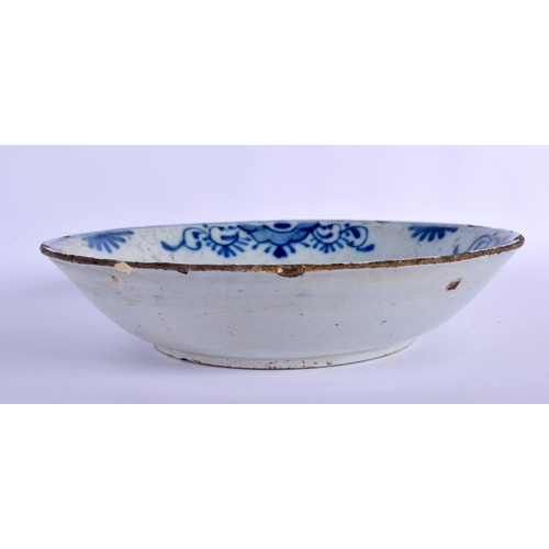 96 - AN 18TH CENTURY DELFT BLUE AND WHITE TIN GLAZED BOWL painted with flowers. 24 cm diameter.