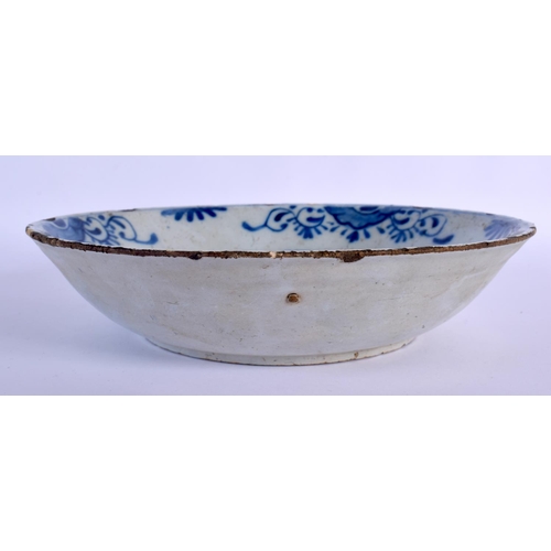 96 - AN 18TH CENTURY DELFT BLUE AND WHITE TIN GLAZED BOWL painted with flowers. 24 cm diameter.