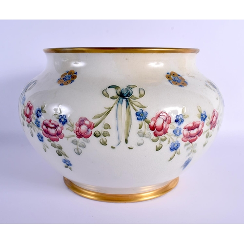99 - A LARGE MOORCROFT MACINTYRE BULBOUS JARDINIERE decorated with flowers. 24 cm x 21 cm.