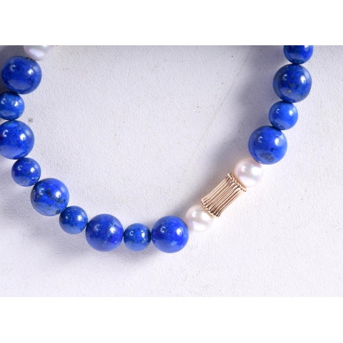 1409 - A STRING OF LAPIS AND PEARL BEADS.  Largest bead 7.7mm, weight 48g