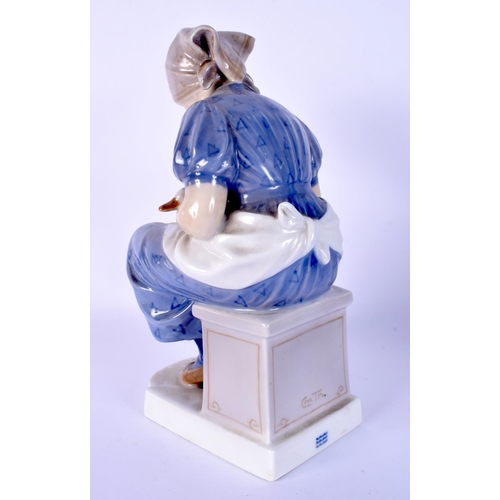 23 - A ROYAL COPENHAGEN FIGURE OF A SEATED FEMALE modelled holding a duck. 23 cm high.
