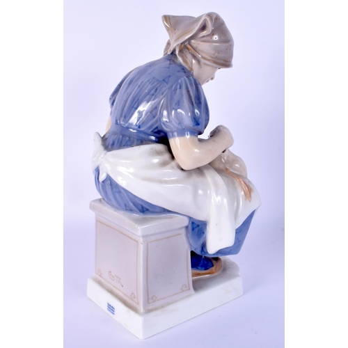 23 - A ROYAL COPENHAGEN FIGURE OF A SEATED FEMALE modelled holding a duck. 23 cm high.