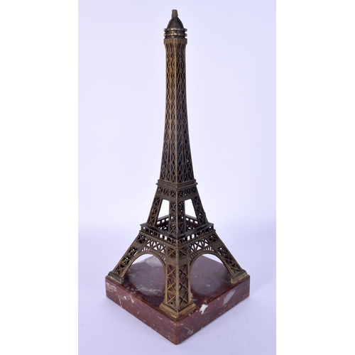 69 - AN UNUSUAL EARLY 20TH CENTURY FRENCH BRONZE AND MARBLE MODEL formed as the Eiffel tower. 27 cm high.