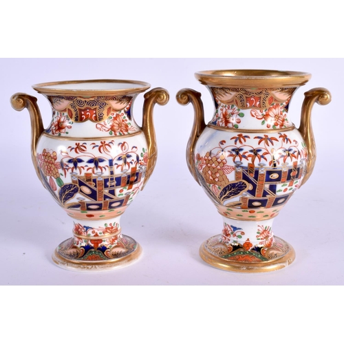 14 - A PAIR OF EARLY 19TH CENTURY SPODE TWIN HANDLED PORCELAIN VASES painted with imari landscapes. 10 cm... 