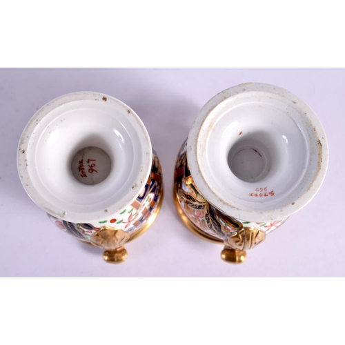 14 - A PAIR OF EARLY 19TH CENTURY SPODE TWIN HANDLED PORCELAIN VASES painted with imari landscapes. 10 cm... 