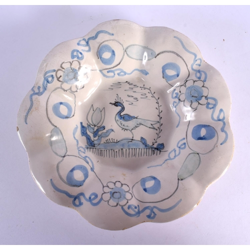 16 - A RARE 18TH CENTURY EUROPEAN TIN GLAZED MELON FORM DISH painted with a bird and foliage. 21.5 cm wid... 