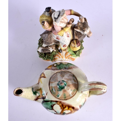 25 - A 19TH CENTURY ENGLISH PORCELAIN FIGURE OF THE TAILORS WIFE together with a majolica glazed teapot. ... 