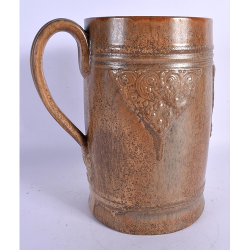 27 - A RARE LARGE ROYAL DOULTON STONEWARE ALE JUG decorated with bacchus mask heads. 24 cm x 12 cm.