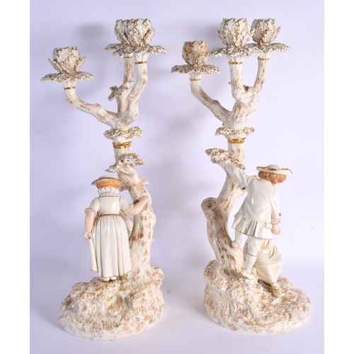 272 - Royal Worcester pair of candelabra after models by James Hadley of a boy and girl collecting birds e... 