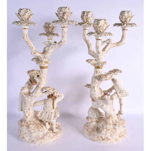 272 - Royal Worcester pair of candelabra after models by James Hadley of a boy and girl collecting birds e... 