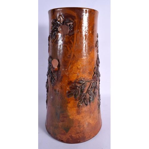 279 - A LARGE EARLY TORQUAY WARE POTTERY JUG overlaid with leaves. 43 cm high.