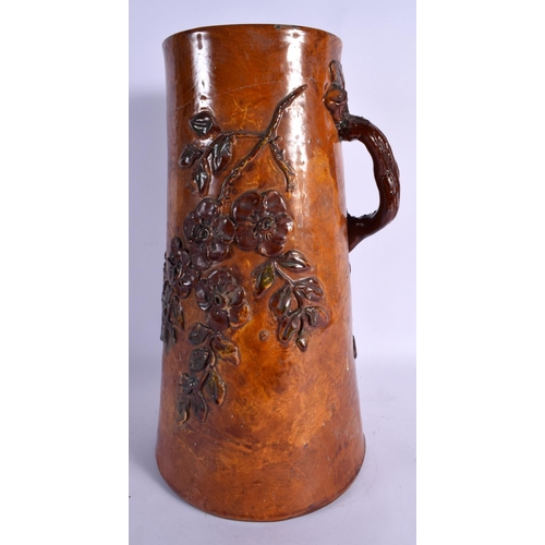 279 - A LARGE EARLY TORQUAY WARE POTTERY JUG overlaid with leaves. 43 cm high.