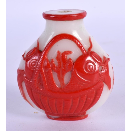 291 - A LATE 19TH CENTURY CHINESE PEKING GLASS SNUFF BOTTLE carved with fish. 6.5 cm x 4.5 cm.