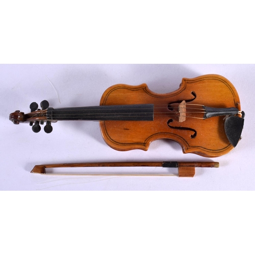 297 - A CASED VINTAGE MINIATURE VIOLIN with bow. 16 cm long.