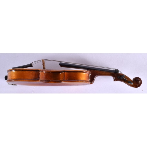 297 - A CASED VINTAGE MINIATURE VIOLIN with bow. 16 cm long.