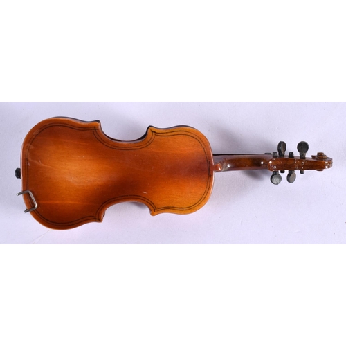 297 - A CASED VINTAGE MINIATURE VIOLIN with bow. 16 cm long.