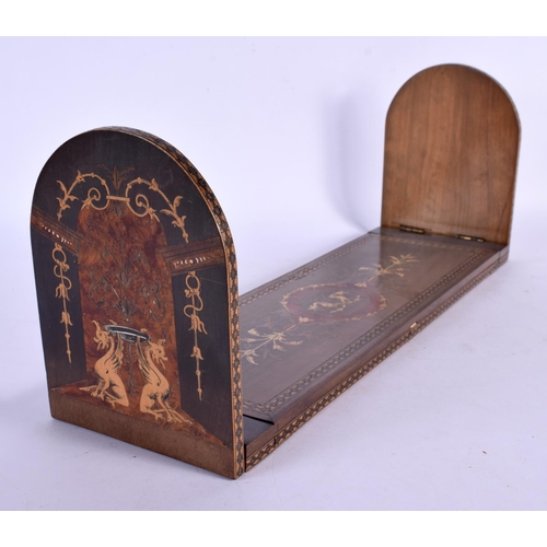 299 - A 19TH CENTURY EUROPEAN PEN WORK SLIDING BOOK RACK decorated with figures. 38 cm wide.