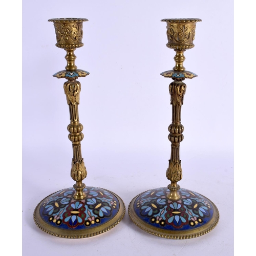 311 - A PAIR OF 19TH CENTURY FRENCH CHAMPLEVE ENAMEL CANDLESTICKS decorated with foliage. 24 cm high.