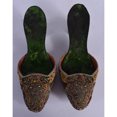 320 - A PAIR OF 18TH CENTURY BEADWORK SLIPPERS decorated with foliage. 24 cm long.